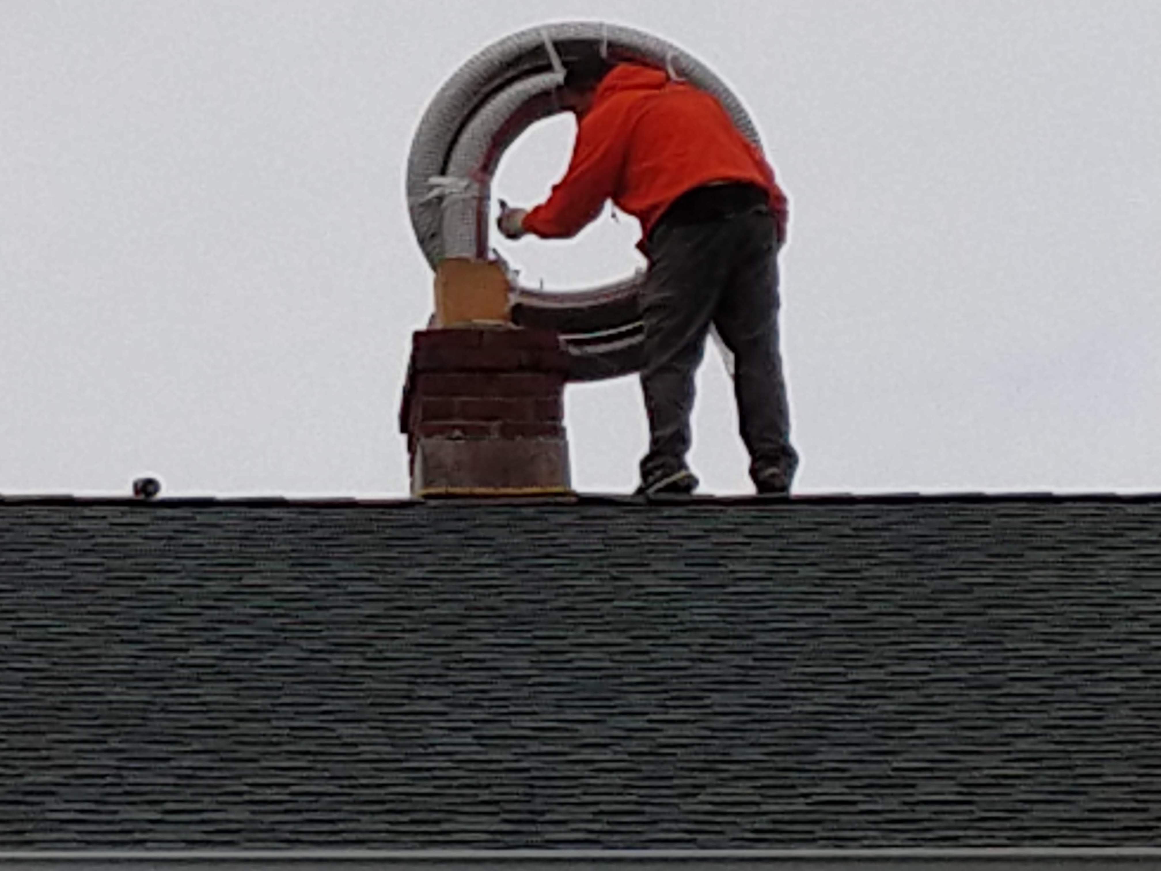 Flexible stainless chimney liner being installed in Manhasset, New York